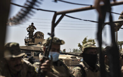 Illustrative: US-backed Syrian Democratic Forces (SDF) fighters sit on their armored vehicles, at al-Sabha town in the eastern countryside of Deir el-Zour, Syria, September 4, 2023. (AP Photo/Baderkhan Ahmad)
