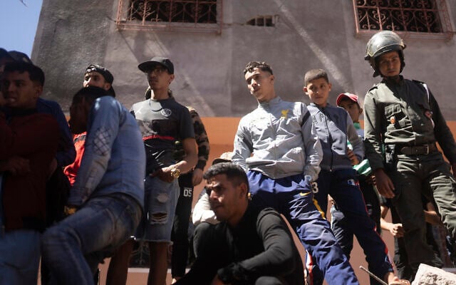 People watch as security forces take part in a rescue operation after the earthquake, in Moulay Brahim village, near the epicentre of the earthquake, outside Marrakesh, Morocco, September 9, 2023. (AP Photo/Mosa'ab Elshamy)