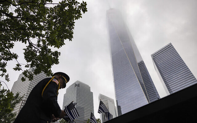 Sam Pulia places flags before the commemoration ceremony of the Sept. 11, 2001, terror attacks, Monday, Sept. 11, 2023, in New York. Americans are looking back on the horror and legacy of 9/11, gathering Monday at memorials, firehouses, city halls and elsewhere to observe the 22nd anniversary of the deadliest terror attack on US soil. (AP/Yuki Iwamura)