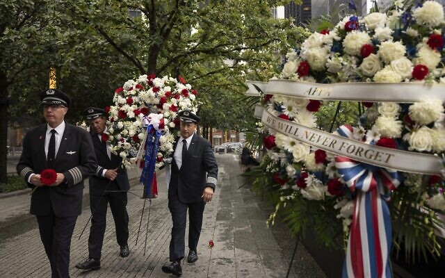People carrying a wreath arrive at the commemoration ceremony of the Sept. 11, 2001, terror attacks, Monday, Sept. 11, 2023, in New York. (AP/Yuki Iwamura)