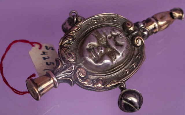 A baby rattle is part of a collection called 'Jewish Silver,' consisting of objects stolen from the Jewish community, and part of a exhibition of looted objects, at the Mauritshuis Museum in The Hague, Netherlands, September 12, 2023. (Peter Dejong/AP) A baby rattle is part of a collection called 'Jewish Silver,' consisting of objects stolen from the Jewish community, and part of a exhibition of looted objects, at the Mauritshuis Museum in The Hague, Netherlands, September 12, 2023. (Peter Dejong/AP)