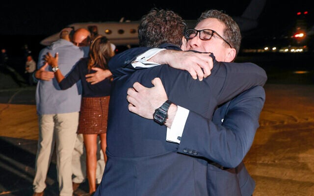 Family members embrace freed Americans Siamak Namazi, Morad Tahbaz and Emad Shargi, as well as two returnees whose names have not yet been released by the US government, who were released in a prisoner swap deal between US and Iran, as they arrive at Davison Army Airfield, Virginia, September 19, 2023. (Jonathan Ernst/Pool via AP) Family members embrace freed Americans Siamak Namazi, Morad Tahbaz and Emad Shargi, as well as two returnees whose names have not yet been released by the US government, who were released in a prisoner swap deal between US and Iran, as they arrive at Davison Army Airfield, Virginia, September 19, 2023. (Jonathan Ernst/Pool via AP)
