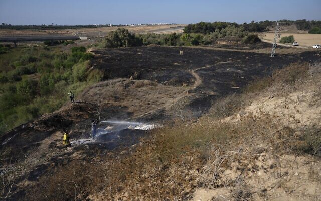 Firefighters work to extinguish fires set by incendiary balloons launched from the Gaza Strip, setting vegetation ablaze near the Israel-Gaza border, September 22, 2023.(AP Photo/Tsafrir Abayov) Firefighters work to extinguish fires set by incendiary balloons launched from the Gaza Strip, setting vegetation ablaze near the Israel-Gaza border, September 22, 2023.(AP Photo/Tsafrir Abayov)