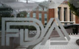 A US Food and Drug Administration building is seen behind FDA logos at a bus stop on the agency's campus in Silver Spring, Maryland, on August 2, 2018. (Jacquelyn Martin/AP)