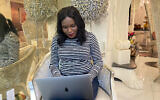 Rose Nakasi, a Ugandan computer scientist, checks her computer during an interview, in New York, September 22, 2023. (Jennifer Peltz/AP))