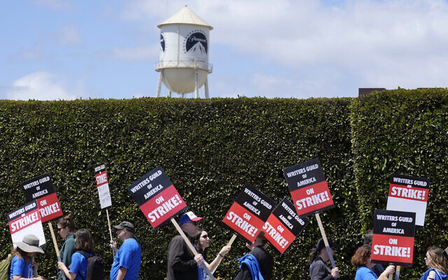 Striking writers take part in a rally in front of Paramount Pictures studio, Tuesday, May 2, 2023, in Los Angeles. A tentative deal was reached, Sunday, September 24, 2023, to end Hollywood’s writers strike after nearly five months. (AP Photo/Chris Pizzello, File) Striking writers take part in a rally in front of Paramount Pictures studio, Tuesday, May 2, 2023, in Los Angeles. A tentative deal was reached, Sunday, September 24, 2023, to end Hollywood’s writers strike after nearly five months. (AP Photo/Chris Pizzello, File)