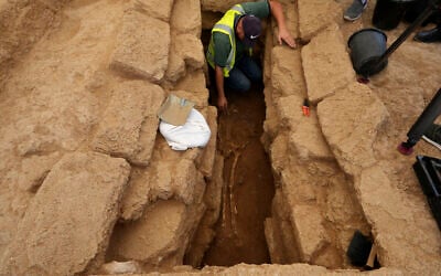 A Palestinian archaeologist removes the sand from a skeleton in a grave at a Roman-era cemetery in Jebaliya northern Gaza Strip, Saturday, September 23, 2023. (AP Photo/Adel Hana)