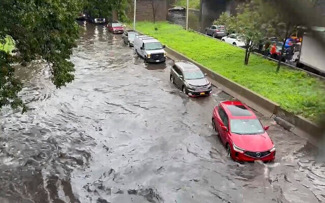 Traffic makes its way through flood waters along the Brooklyn Queens Expressway, Friday, September 29, 2023, in New York. (AP Photo/Robert Bumsted)