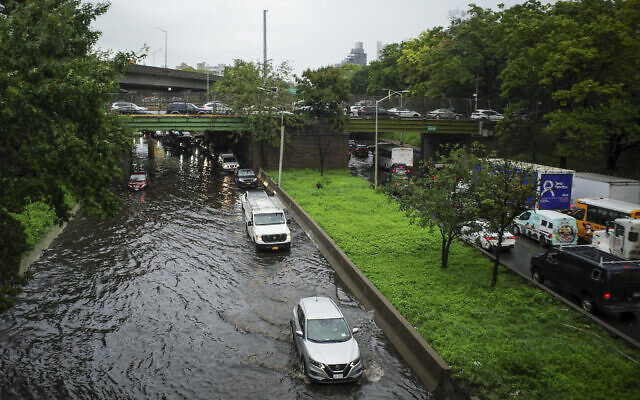 Traffic makes its way through flood waters along the Brooklyn Queens Expressway, September 29, 2023, in New York. (AP Photo/Robert Bumsted) Traffic makes its way through flood waters along the Brooklyn Queens Expressway, September 29, 2023, in New York. (AP Photo/Robert Bumsted)