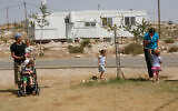 Israeli settlers and their children in front of a caravan in the then-illegal West Bank outpost of Avigayil in the Hebron Hills, May 25, 2009. (Miriam Alster/Flash90)