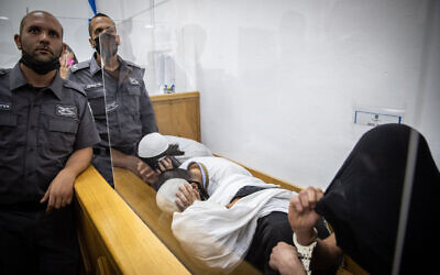 Suspects in an attack on an Arab man at the Mahane Yehuda market in Jerusalem, at a May 30, 2021 hearing at Jerusalem District Court (Yonatan Sindel/Flash90)