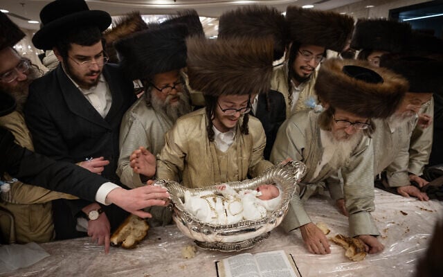 Ultra-Orthodox men at a Pidyon Ha'ben ceremony in Mea Shearim, Jerusalem, September 2, 2023 (Chaim Goldberg/Flash90) Ultra-Orthodox men at a Pidyon Ha'ben ceremony in Mea Shearim, Jerusalem, September 2, 2023 (Chaim Goldberg/Flash90)