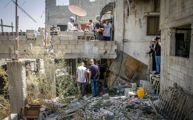 Palestinians inspect a damaged house after an Israeli military raid in the West Bank city of Jenin, September 4, 2023. (Nasser Ishtayeh/Flash90) Palestinians inspect a damaged house after an Israeli military raid in the West Bank city of Jenin, September 4, 2023. (Nasser Ishtayeh/Flash90)