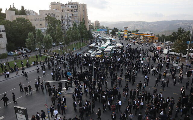 Haredi men block the entrance to Jerusalem in protest of the arrest of an ultra-Orthodox military draft dodger, September 13, 2023. (Yonatan Sindel/Flash90)
