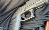 A pistol retrieved from the scene where a man was suspected of shooting his wife dead and then attempting to take his own life, causing himself moderate injuries in Rahat, September 11, 2023. (Israel Police)