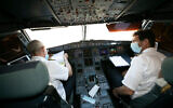 Illustrative: Crew on a flight between Tel Aviv and Eilat on August 17, 2020. (Olivier Fitoussi/Flash90)