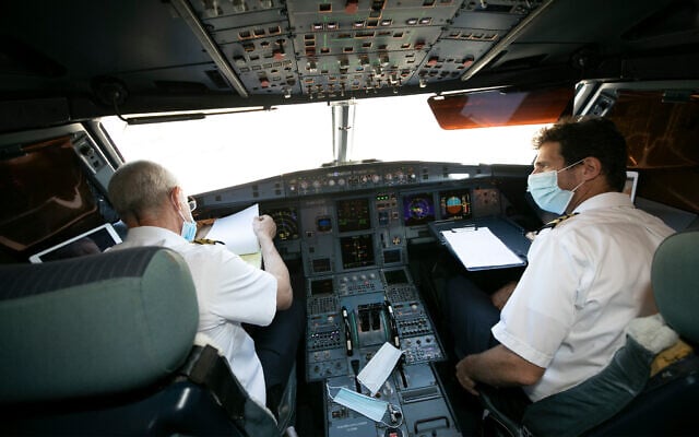 Illustrative: Crew on a flight between Tel Aviv and Eilat on August 17, 2020. (Olivier Fitoussi/Flash90)