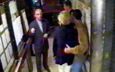 A picture taken from the Ritz Hotel security video, released in London by the Al Fayed family, shows Diana and her friend Dodi Fayed waiting at the back entrance for their car to leave the Parisian palace on August 31, 1997, shortly before the accident that cost them their lives. Henri Paul, the driver, is seen behind the couple. (WTN/AFP)