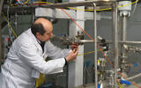 Illustrative: An unidentified International Atomic Energy Agency (IAEA) inspector disconnects the connections between the twin cascades for 20 percent uranium production at the nuclear research center of Natanz, some 300 kilometers south of Tehran, Iran, on January 20, 2014. (KAZEM GHANE/IRNA/AFP)
