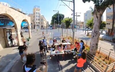 Demonstrators block the tracks of the Tel Aviv light rail in protest of it not running during Shabbat, Friday, September 1, 2023 (video screenshot)