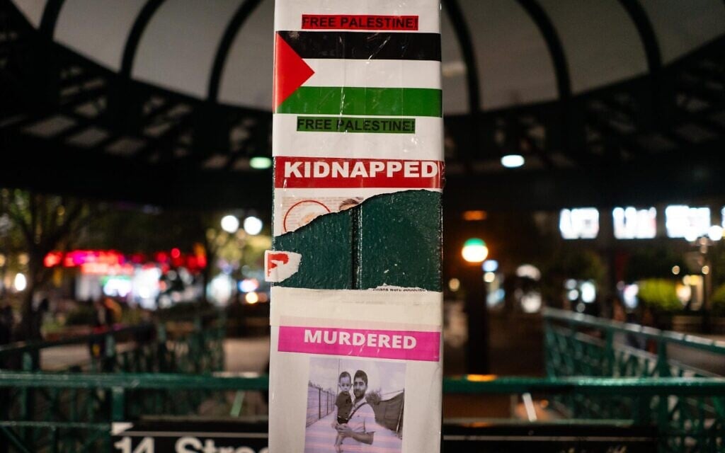 A torn poster about Israeli hostages surrounded by pro-Palestinian messages in New York City’s Union Square, October 16, 2023. (Luke Tress/ JTA)