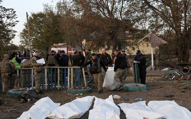 Ukrainian policemen carry bodies out of a destroyed shop and cafe after a Russian strike in the village of Groza, some 30 kilometers west of Kupiansk, eastern Ukraine, on October 5, 2023 (Anatolii Stepanov/AFP) Ukrainian policemen carry bodies out of a destroyed shop and cafe after a Russian strike in the village of Groza, some 30 kilometers west of Kupiansk, eastern Ukraine, on October 5, 2023 (Anatolii Stepanov/AFP)