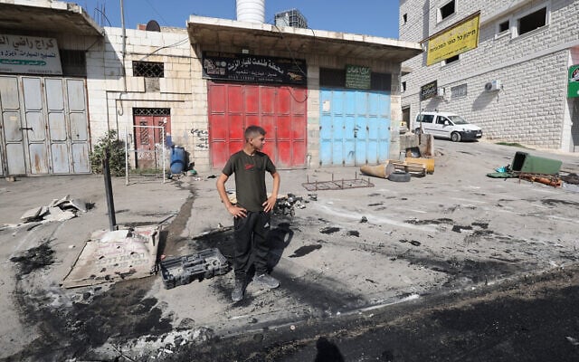 A Palestinian man inspects the damage in the village of Huwara in the West Bank on October 6, 2023, after an overnight attack by Israeli settlers. (Jaafar Ashtiyeh/AFP) A Palestinian man inspects the damage in the village of Huwara in the West Bank on October 6, 2023, after an overnight attack by Israeli settlers. (Jaafar Ashtiyeh/AFP)