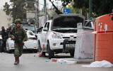 An Israeli soldier stands guard next to a pickup truck from Gaza mounted with a machine gun in the southern city of Sderot on October 7, 2023, after the Palestinian terror group Hamas launched a large-scale surprise attack on Israel (Oren ZIV / AFP)