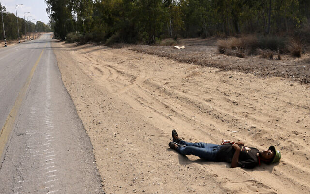 A corpse of a Palestinian terrorist lies along a road in an undisclosed location on the border with the Gaza Strip on October 8, 2023. (Menahem KAHANA/ AFP) A corpse of a Palestinian terrorist lies along a road in an undisclosed location on the border with the Gaza Strip on October 8, 2023. (Menahem KAHANA/ AFP)