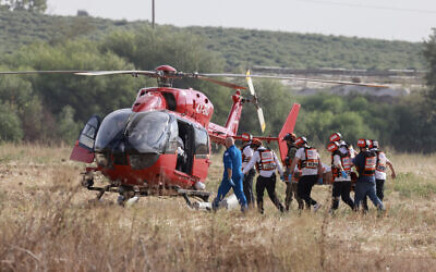 Israeli rescue teams evacuate a wounded person by helicopter near the southern city of Sderot on October 7, 2023 (Menahem KAHANA / AFP)