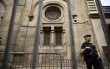 A French riot policeman stands guard outside the Paris Synagogue, two days after security measures were reinforced near Jewish temples and schools, in central Paris, on October 9, 2023. (JULIEN DE ROSA / AFP)
