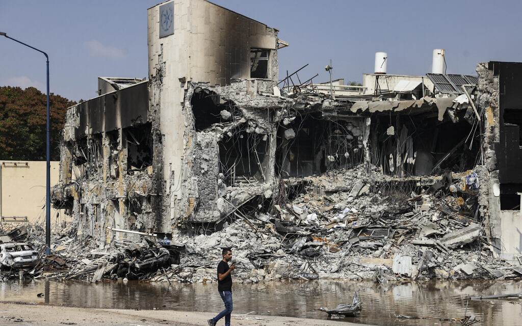 A man walks past the Sderot police station, which was destroyed during battles to dislodge Hamas gunmen inside, on October 8, 2023. (Ronaldo Schemidt/AFP)