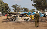 Israeli troops inspect the ravaged site of the attack on the Supernova desert music festival by Palestinian terrorists near Kibbutz Reim in the Negev desert, October 10, 2023. (JACK GUEZ / AFP)