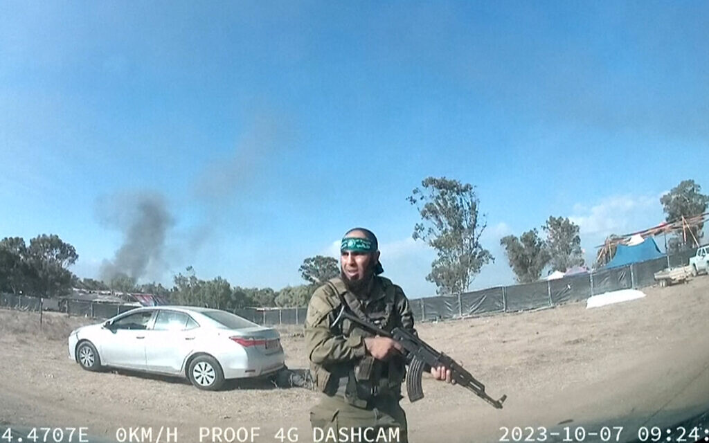 A grab from a UGC video posted on the Telegram channel 'South First Responders' on October 9, 2023, shows a Palestinian terrorist walking around the Supernova music festival, near Kibbutz Re'im in southern Israel on October 7. (South First Responders/AFP) A grab from a UGC video posted on the Telegram channel 'South First Responders' on October 9, 2023, shows a Palestinian terrorist walking around the Supernova music festival, near Kibbutz Re'im in southern Israel on October 7. (South First Responders/AFP)
