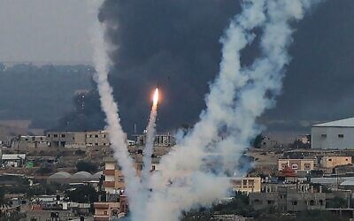 Hamas terrorists fire rockets towards Israel from Rafah, in the southern Gaza Strip, on October 11, 2023. (SAID KHATIB / AFP)
