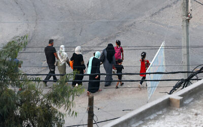 Palestinians flee to safer areas in Gaza City after Israeli air strikes, on October 13, 2023. (MOHAMMED ABED/AFP)