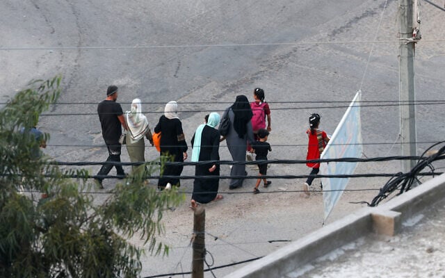 Palestinians flee to safer areas in Gaza City after Israeli air strikes, on October 13, 2023. (MOHAMMED ABED/AFP)