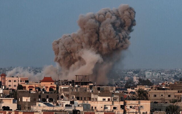 Smoke plumes rising above buildings during an Israeli strike on Rafah in the southern Gaza Strip on October 14, 2023. (Said Khatib/AFP) Smoke plumes rising above buildings during an Israeli strike on Rafah in the southern Gaza Strip on October 14, 2023. (Said Khatib/AFP)