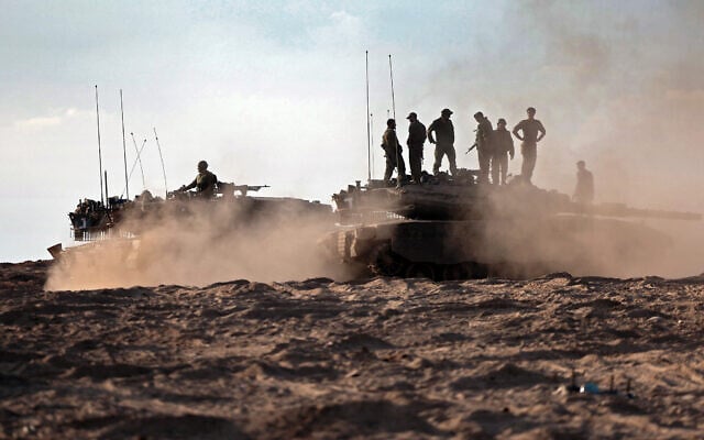 Israeli troops and tanks gather in a field near Kibbutz Be'eri in southern Israel on October 14, 2023. (Thomas COEX / AFP) Israeli troops and tanks gather in a field near Kibbutz Be'eri in southern Israel on October 14, 2023. (Thomas COEX / AFP)