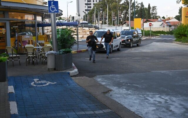 People run to take cover as sirens sound in the northern kibbutz of Kfar Giladi near the border with Lebanon, on October 17, 2023. (Yuri Cortez/AFP) People run to take cover as sirens sound in the northern kibbutz of Kfar Giladi near the border with Lebanon, on October 17, 2023. (Yuri Cortez/AFP)