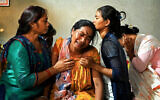 Manju Devi Danguara (2nd left), the mother of Ashish Chaudhary, is consoled by family members at her residence in the Kailali district of Sudurpashchim province as she mourns the loss of her son, who was killed in Hamas's devastating onslaught in Israel, October 13, 2023. (Prakash MATHEMA/AFP)
