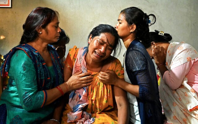 Manju Devi Danguara (2nd left), the mother of Ashish Chaudhary, is consoled by family members at her residence in the Kailali district of Sudurpashchim province as she mourns the loss of her son, who was killed in Hamas's devastating onslaught in Israel, October 13, 2023. (Prakash MATHEMA/AFP) Manju Devi Danguara (2nd left), the mother of Ashish Chaudhary, is consoled by family members at her residence in the Kailali district of Sudurpashchim province as she mourns the loss of her son, who was killed in Hamas's devastating onslaught in Israel, October 13, 2023. (Prakash MATHEMA/AFP)