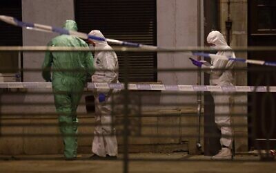 Belgian police officers from the forensic service at the scene of a suspected terror shooting in which two people were killed, in Brussels on October 16, 2023. (Kenzo Tribouillard/AFP)