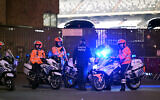 Police officers onboard motorbikes stand guard outside the King Baudouin Stadium after two Swedes were shot dead in an attack in Brussels on October 16, 2023. (John Thys/AFP)