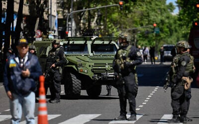Police officers stand guard on Mayo Avenue in Buenos Aires after the Israeli embassy received a bomb threat, Oct. 18, 2023 (Luis ROBAYO / AFP)