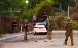 Israeli security forces inspect a site where a rocket launched from Lebanon landed in the northern city of Kiryat Shmona near the border on October 19, 2023. (Jalaa MAREY / AFP)