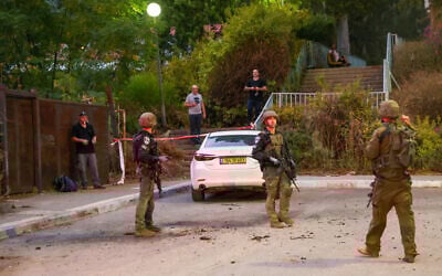 Israeli security forces inspect a site where a rocket launched from Lebanon landed in the northern city of Kiryat Shmona near the border on October 19, 2023. (Jalaa MAREY / AFP)