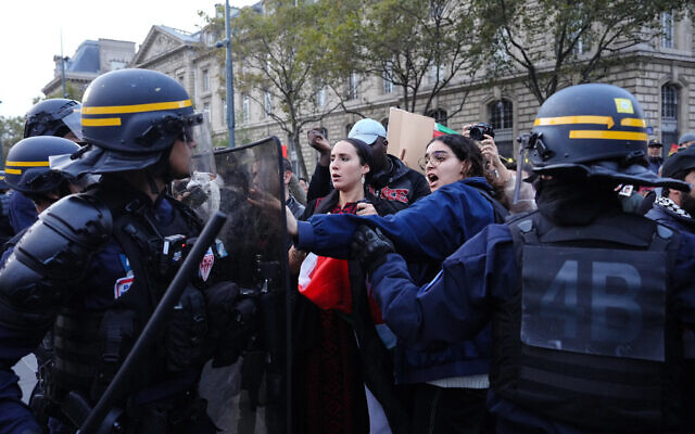 A protester gestures as protesters face French Republican Security Corps (CRS - Compagnies Republicaines de Securite) police officers during a demonstration in support of Palestinians at Place de la Republique during in Paris, on October 19, 2023. (Photo by Dimitar DILKOFF / AFP) A protester gestures as protesters face French Republican Security Corps (CRS - Compagnies Republicaines de Securite) police officers during a demonstration in support of Palestinians at Place de la Republique during in Paris, on October 19, 2023. (Photo by Dimitar DILKOFF / AFP)