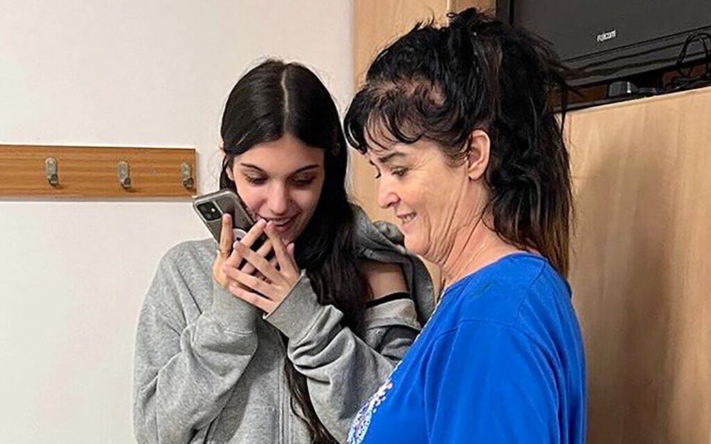 This handout picture courtesy of the United States Embassy in Jerusalem, taken on October 20, 2023, shows Natalie Raanan (L) and her mother Judith Raanan speaking on the phone with US President Joe Biden, after they were held hostage and later released by the Gaza-ruling Hamas terror group. (US Embassy in Jerusalem/AFP)