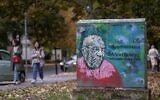 A mural portraying Polish-Israeli Holocaust historian and educator Alex Dancyg, who was taken hostage from Kibbutz Nir Oz on October 7, 2023, with the subtitle referring to him as 'Ambassador of Dialogue,' can be seen in Warsaw, Poland on October 19, 2023. (Wojtek Radwanski/AFP)